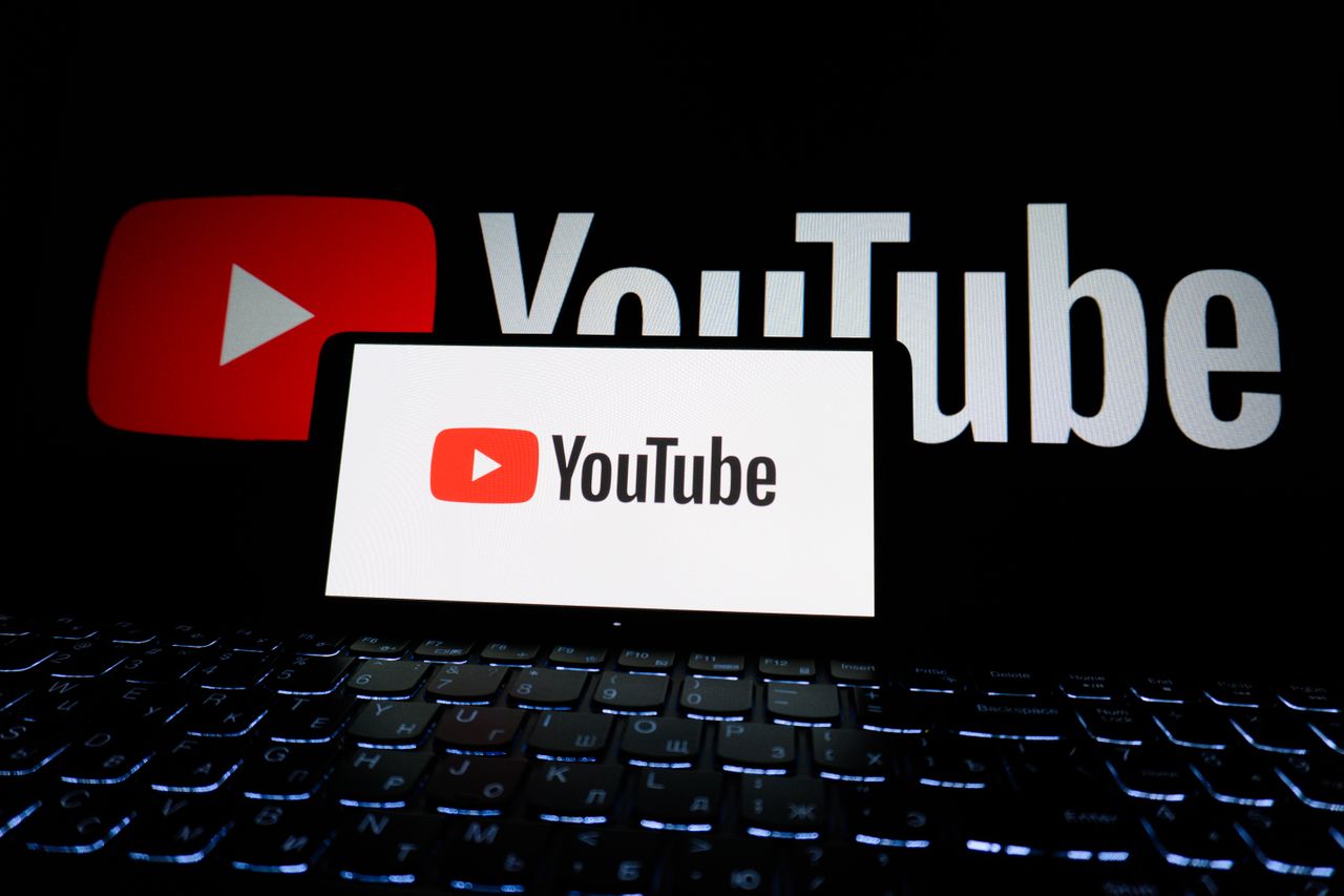 services-01 Close-up of YouTube logo displayed on a laptop screen in a dark environment.